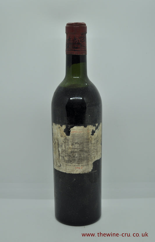 1962 vintage red wine. chateau Lafite 1962. France, Bordeaux. The label is bin soiled with some bis missing. The vintage is visible and the partial chateau name. Wine level is top shoulder. Immediate delivery. Free  local delivery. Gift wrapping available