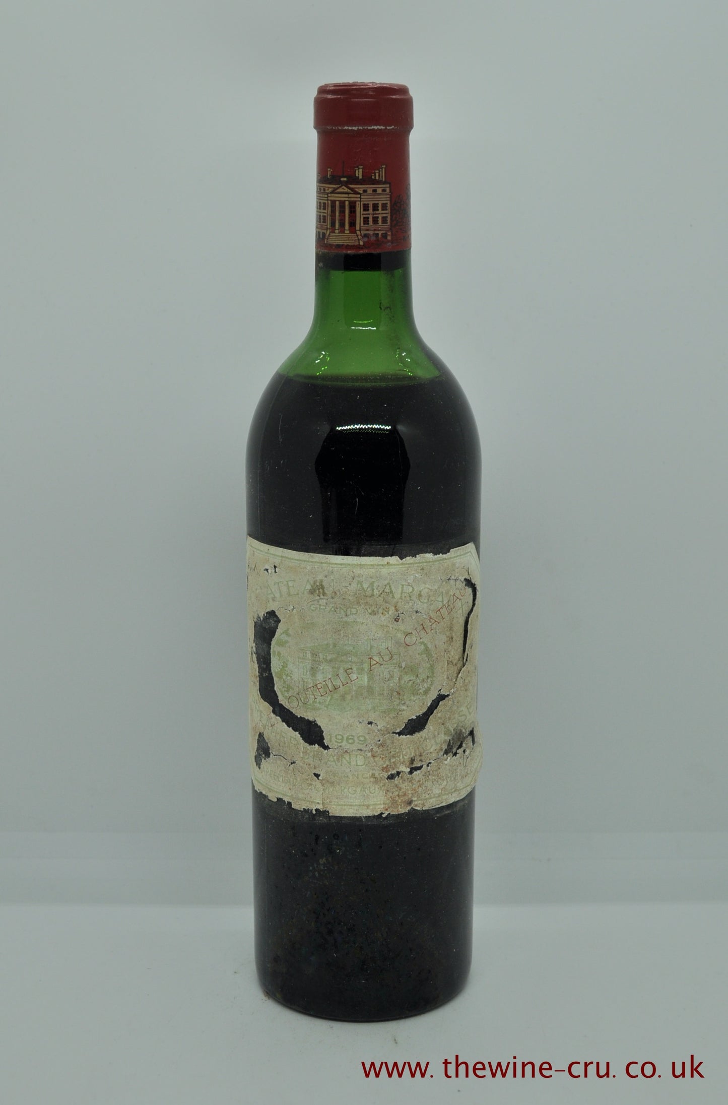 1969 vintage red wine. Chateau Margaux, France, Bordeaux. The level is high shoulder. The label is bin soiled but vintage and chateau are legible. Immediate delivery. Free local delivery. Gift wrapping available