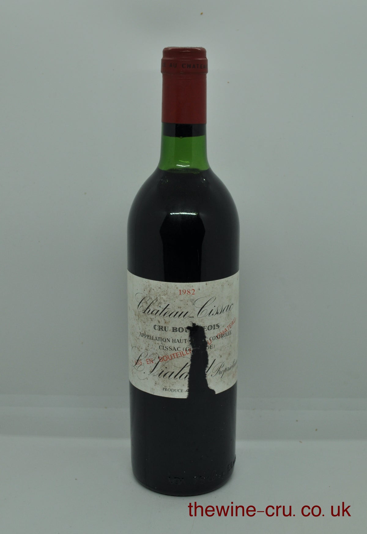 1982 vintage red wine from the Haut Medoc, Bordeaux. The bottle is in good general condition, but the label does have a wide tear in it. The chateau name and vintage are visible. Immediate delivery. Free local delivery. Gift wrapping available.