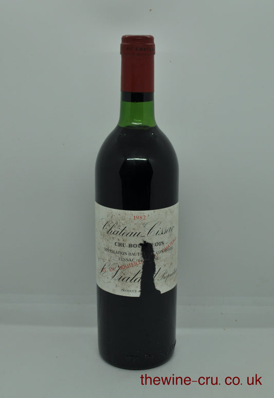 1982 vintage red wine from the Haut Medoc, Bordeaux. The bottle is in good general condition, but the label does have a wide tear in it. The chateau name and vintage are visible. Immediate delivery. Free local delivery. Gift wrapping available.