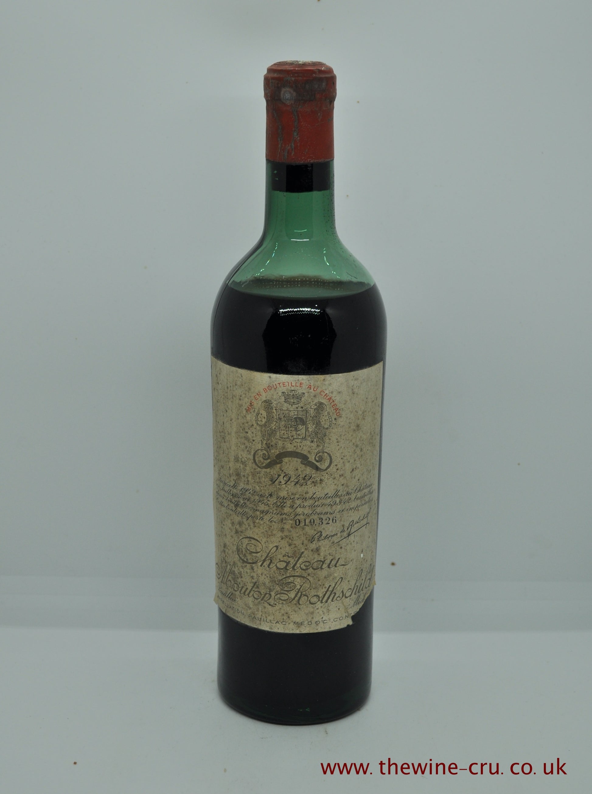 1942 vintage red wine from Bordeaux, France. The capsule has a little corrosion. The label is bin soiled with the important information visible. The wine level is mid shoulder. Immediate delivery. Free local delivery. Gift wrapping available.