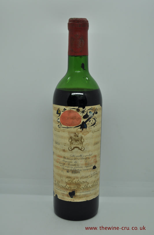 1969 vintage red wine. Chateau Mouton Rothschild 1969. France, Bordeaux. The bottle has a corroded capsule and bin soiled label. The wine level is mid shoulder. immediate delivery. free local delivery. Gift wrapping available.