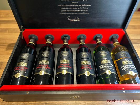 Set of wine bottles in a wooden box with visible branding.