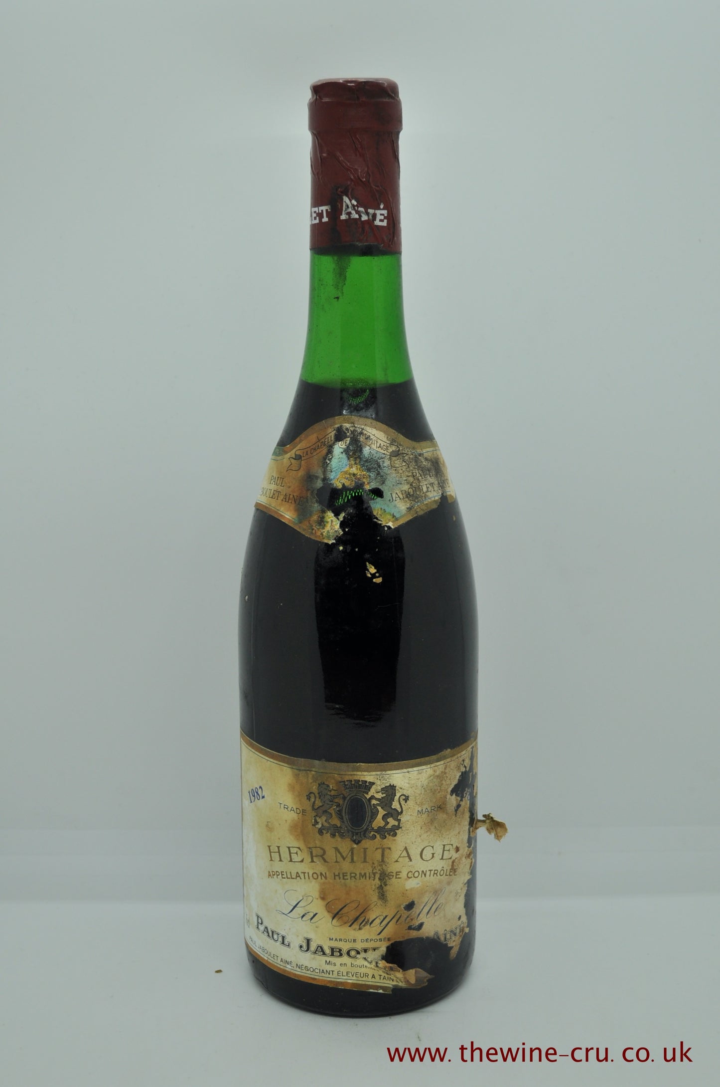 1982 vintage red wine. The label is recognisable, including the vintage, but heavily in soiled.