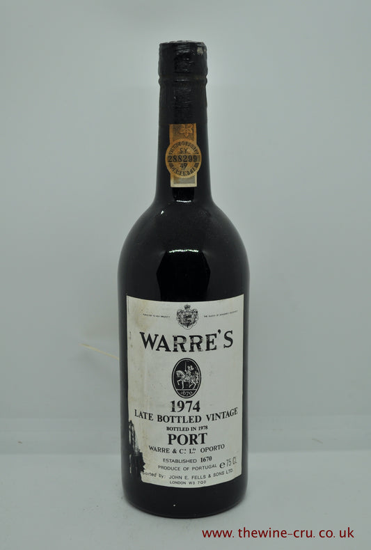 1974 vintage red port wine. Warre's Late Bottle Vintage Port 1974. Bottled in 1978. Portugal. The bottle is in good general condition. One corner of the label is missing and the level of the wine is top shoulder. Immediate delivery. free local delivery. Gift wrapping available.